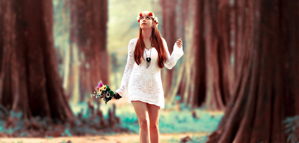Woman Carrying Flowers While Standing at Woods